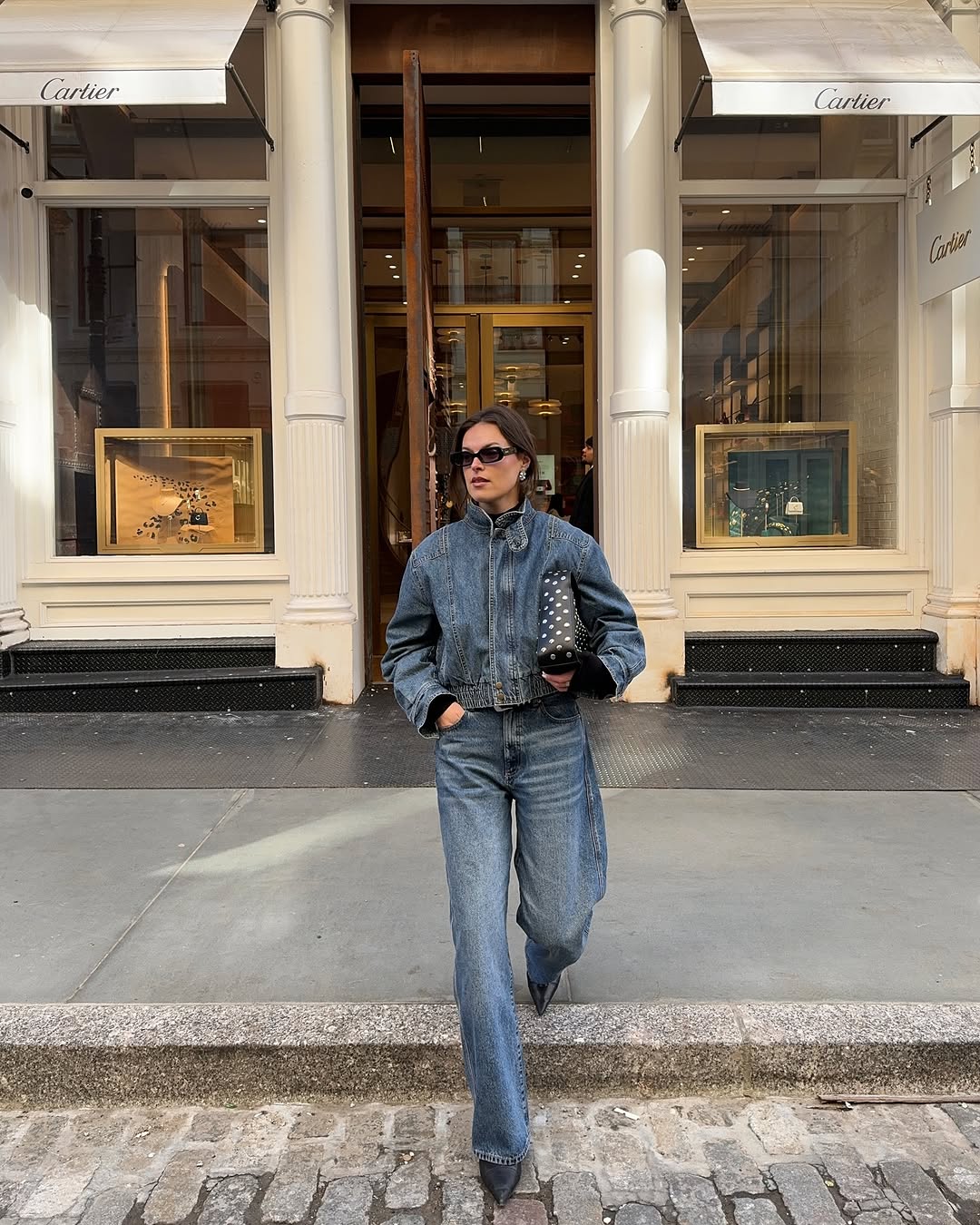 woman wearing dirty denim wash jeans fall denim trend 2025