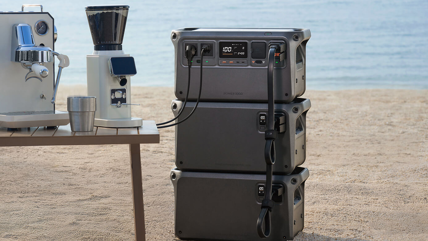 DJI Power 1000 and DJI Power Expansion Battery 2000 on a beach powering a coffee machine