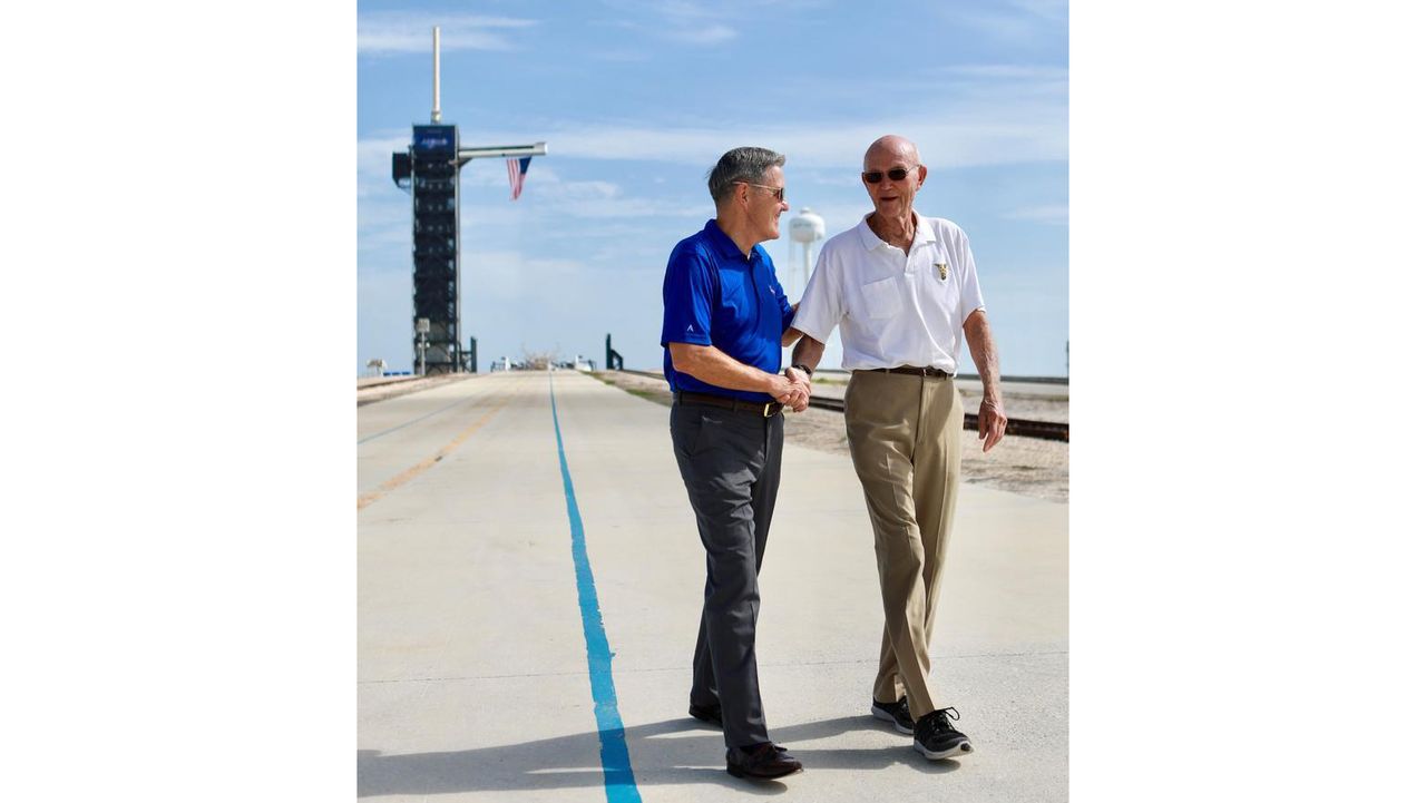 Astronaut Michael Collins (right) and NASA Kennedy Space Center Director Bob Cabana (left) shake hands at Launch Complex 39A on the 50th anniversary of the Apollo 11 launch, July 16, 2019.