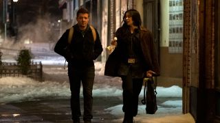 Kate Bishop (Hailee Steinfeld) and Clint Barton (jeremy renner) walk on a street in hawkeye