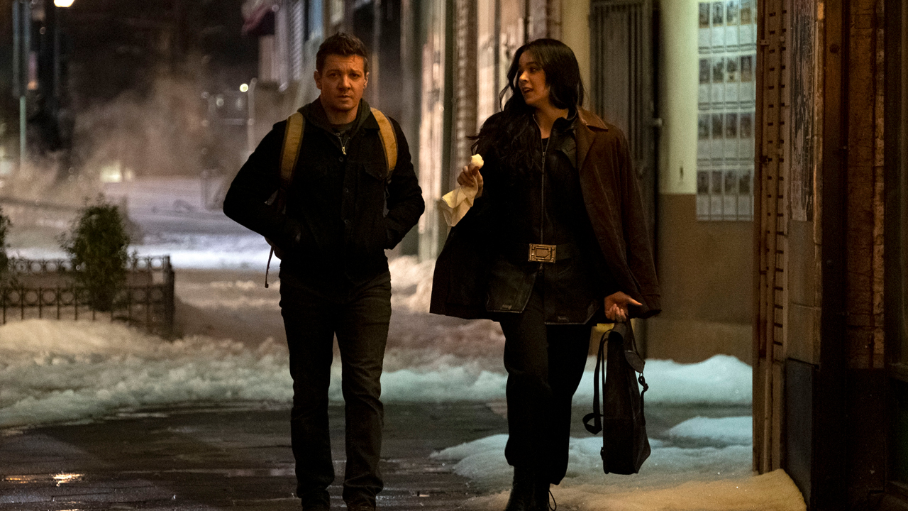 Kate Bishop (Hailee Steinfeld) and Clint Barton (Jeremy Renner) walking down a street in Hook