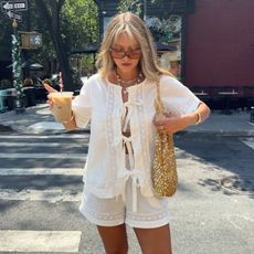 A woman in New York wearing a white two piece with bright blonde hair