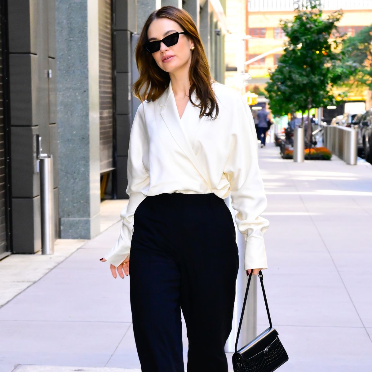 Lily James wears a white blouse and black trousers while out in New York.