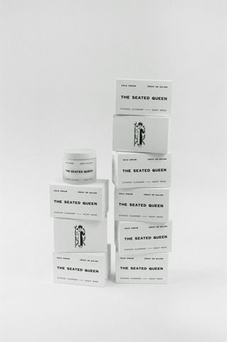 The Seated Queen cold cream in white packaging against grey background