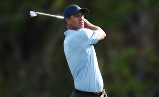 Adam Scott plays an iron shot