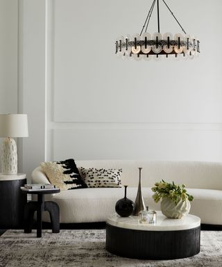 Living room ceiling light ideas with a black hoop light in a white room