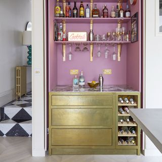 Kitchen with pink and gold built-in bar area.