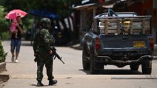 A Colombian soldier stands guard during a conflict in the country's Caceres Municipality