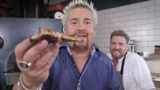 Guy Fieri eating pizza in Diners, Drive-Ins and Dives
