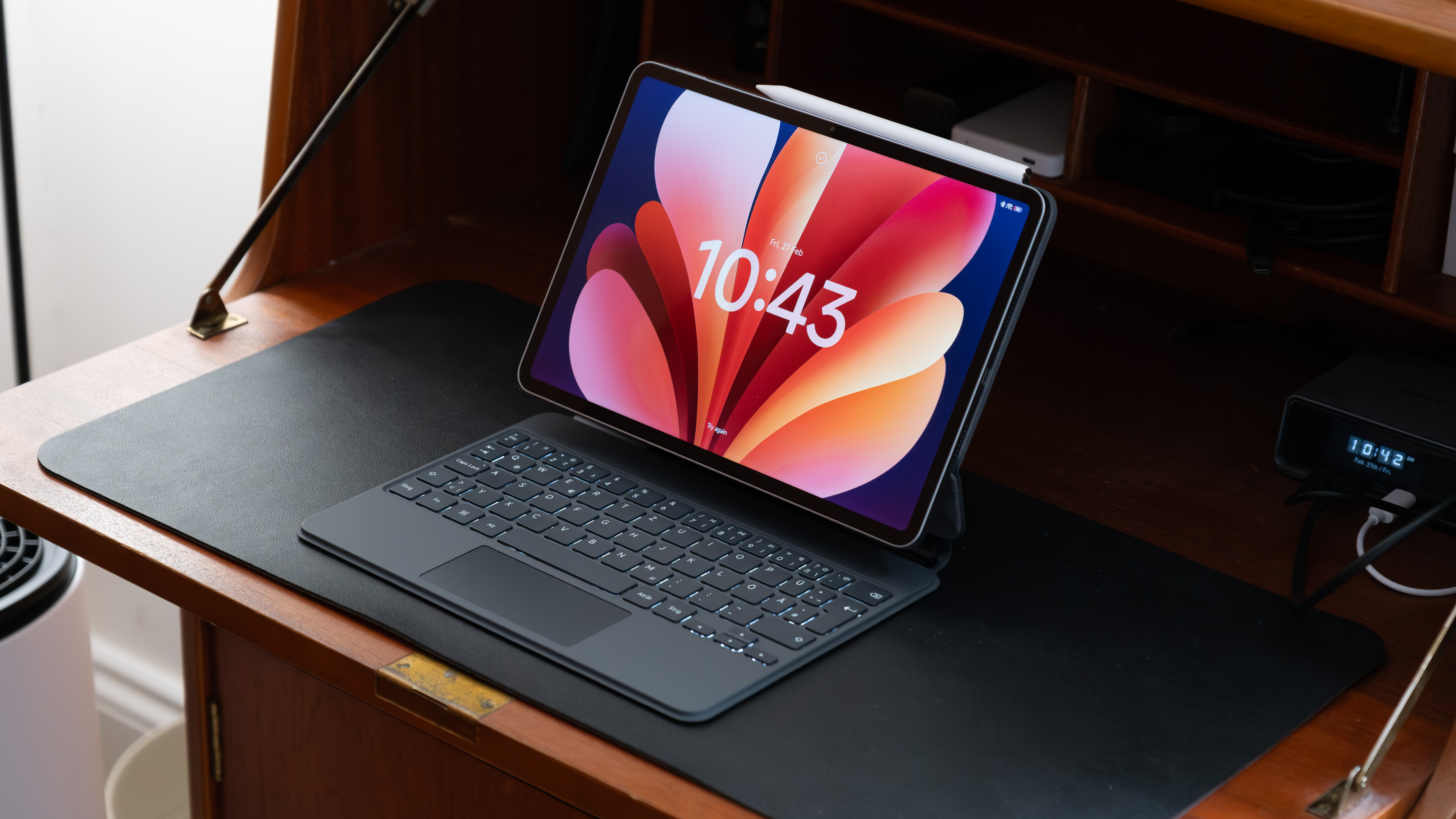 Xiaomi Pad 8 Pro positioned on a desk with keyboard cover attached, viewed from a slight angle to show the screen, trackpad and keys.