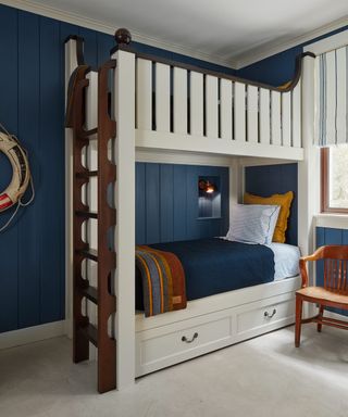 bunk room with white bunks and blue walls