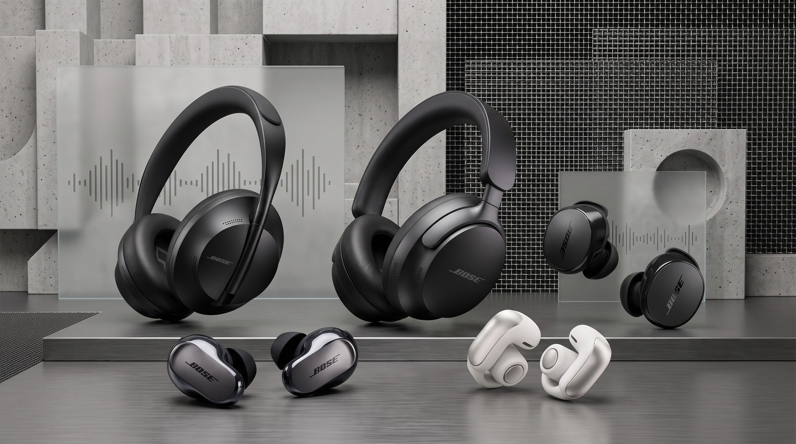 A collage of five Bose headphones and earbuds sitting on a shiny metal surface and with a grey concrete wall in the background