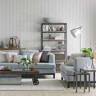 living room with blue sofa set and cushion