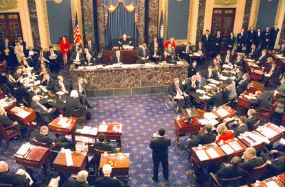 During an impeachment trial prompted by the Lewinsky sex scandal, presidered over by Chief Justice William Rehnquist (1924 - 2005) (center rear), the United States Senate votes on articles of