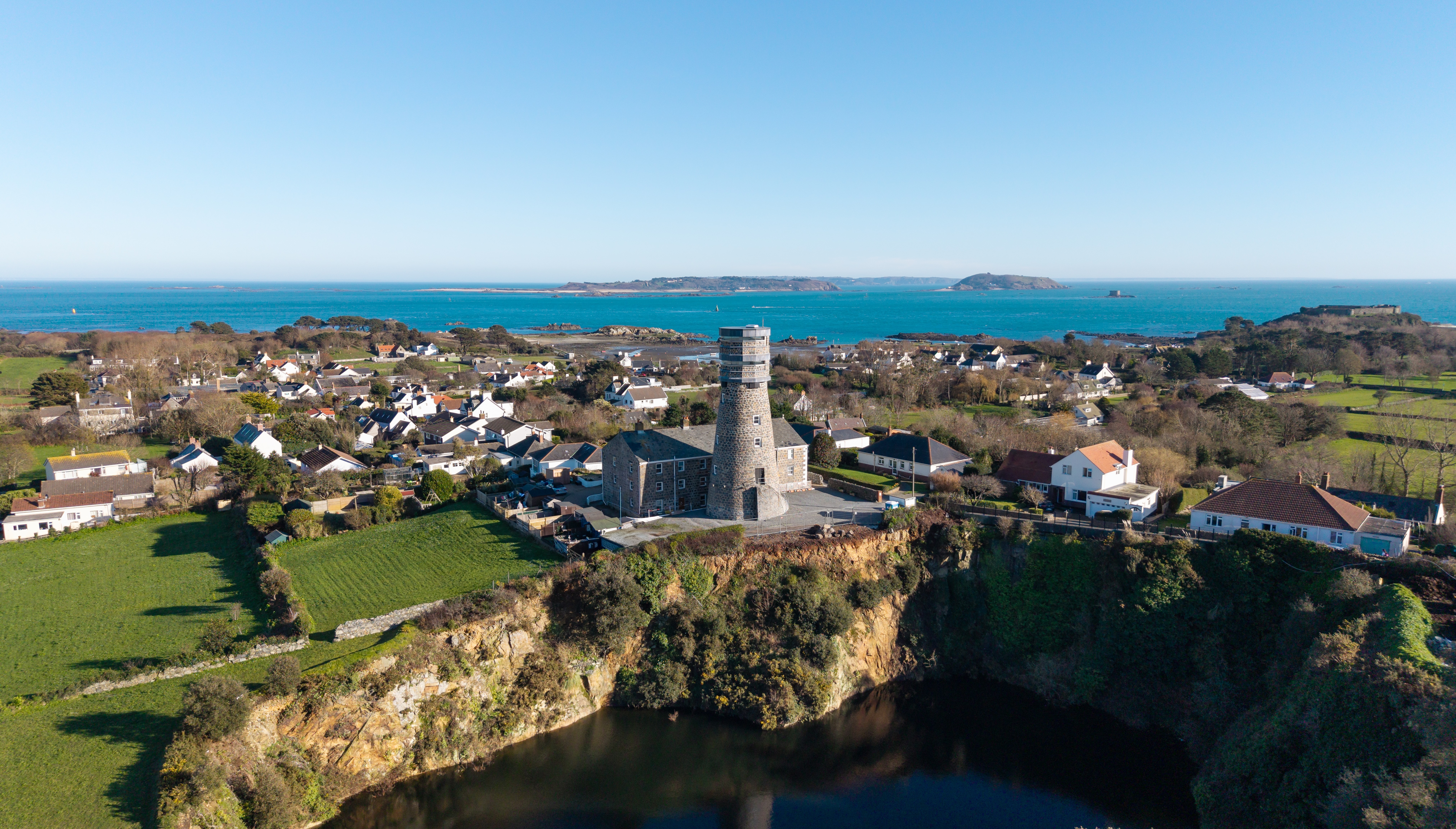 Images of a disused but restored Mill tower on the isle of Guernsey. It overlooks a quarry filled with water
