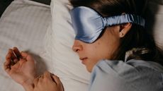 A woman asleep while wearing a sleep mask