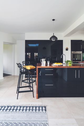 contemporary monochrome kitchen extension with large kitchen island and bar stool, image by james french