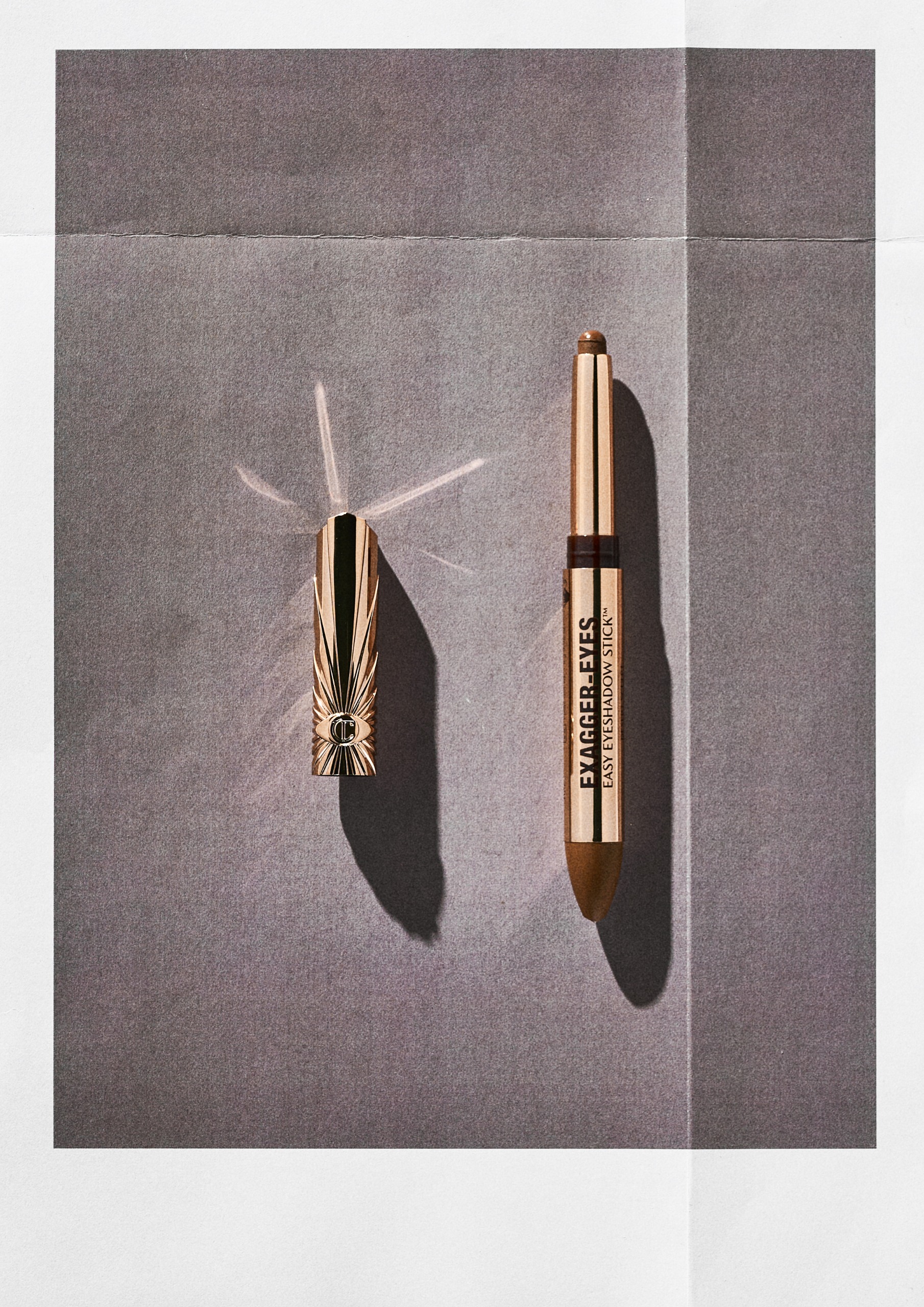 Charlotte Tilbury Exagger-Eyes Easy Eyeshadow Stick on a grey background