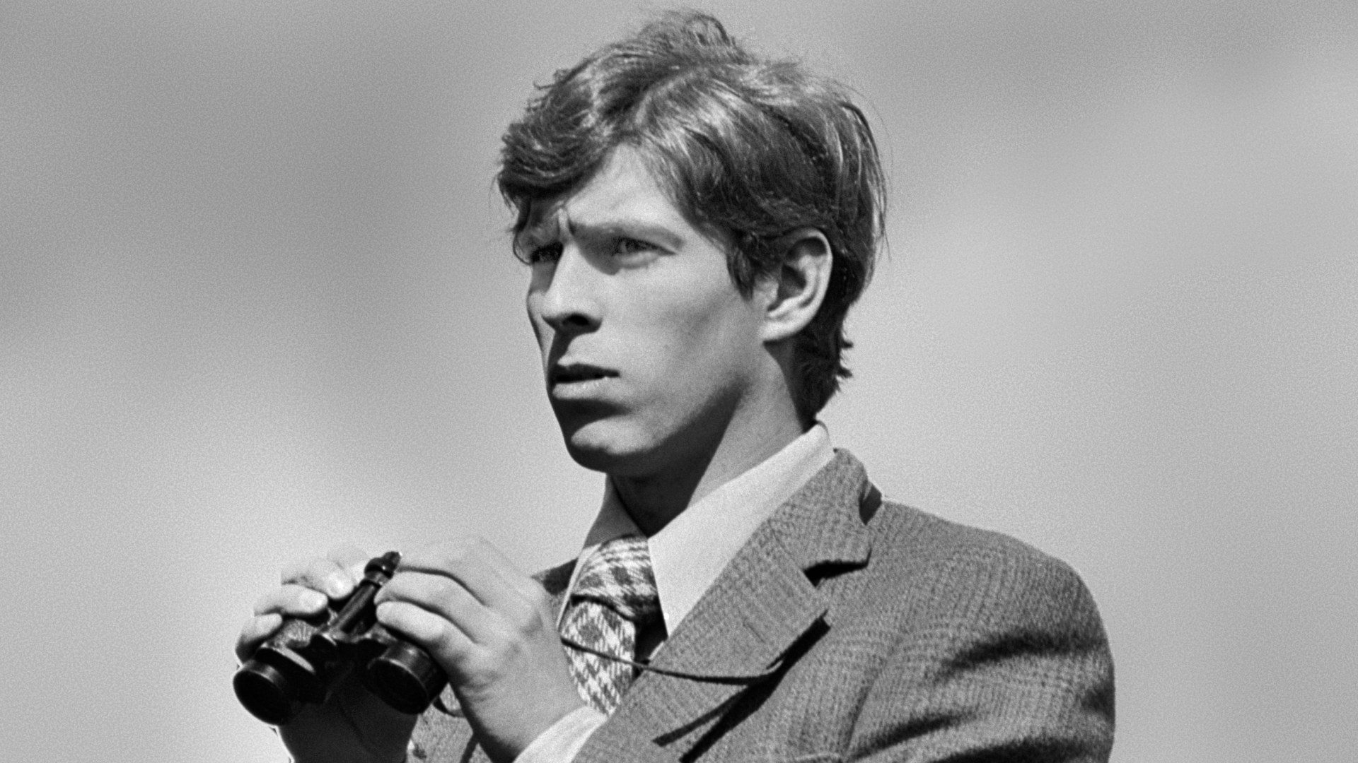 Prince Andrew holding binoculars in the 1970s