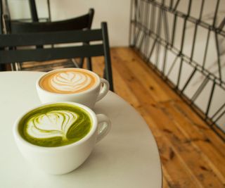 a matcha and a cup of coffee on a cafe table