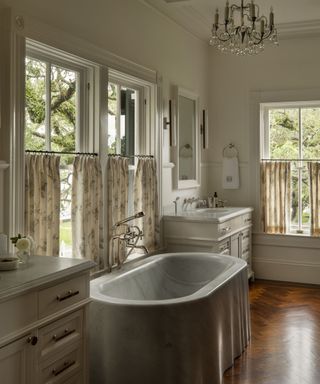 bathroom with half curtains and freestanding bath