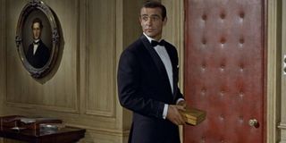 Sean Connery holds a gold box, wearing a tuxedo, in Dr. No