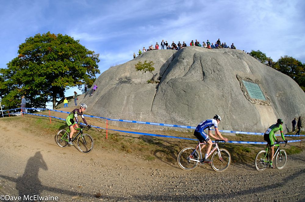 A group passes by the Tablet Rock in Stage Fort Park