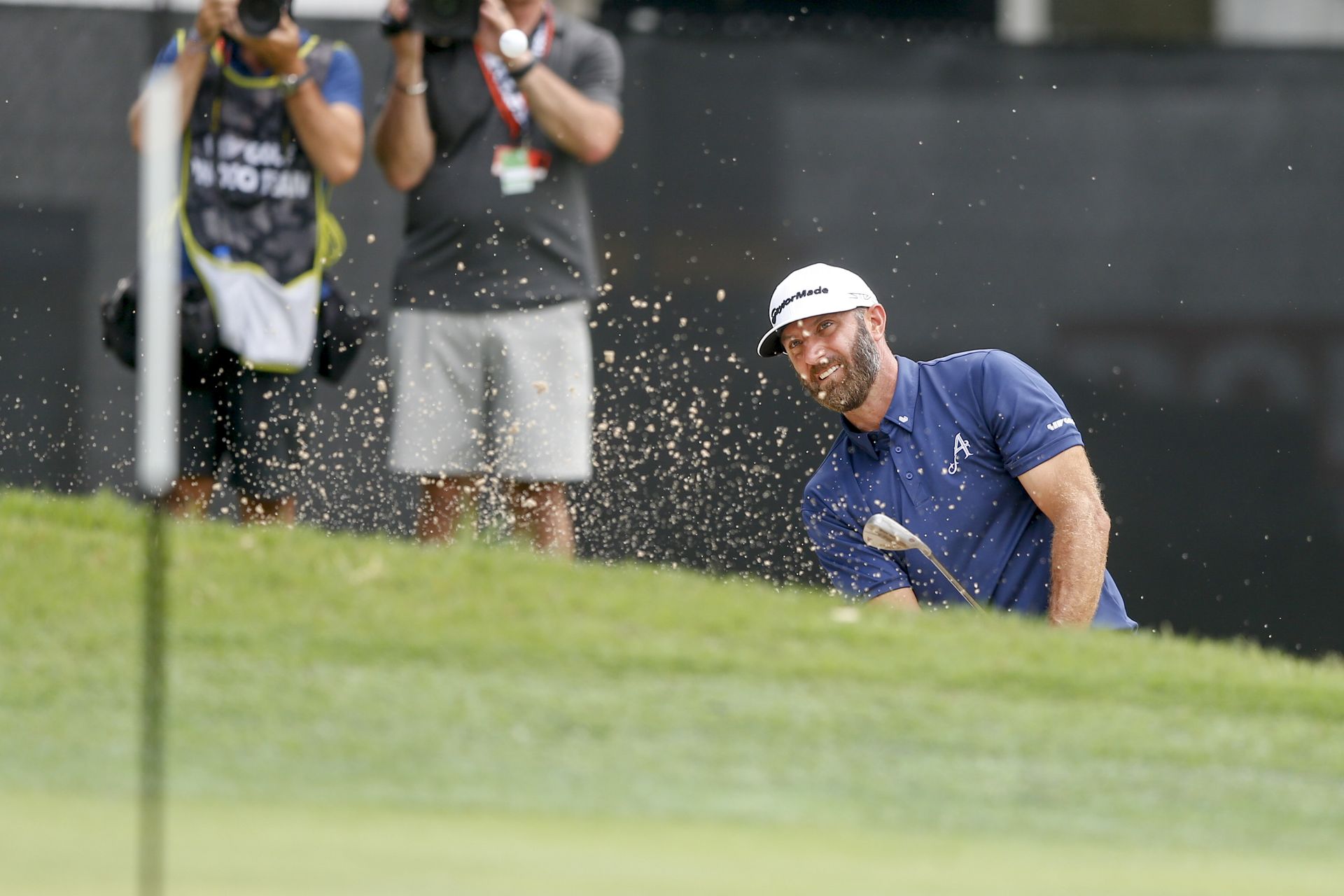 Dustin Johnson strikes a bunker shot