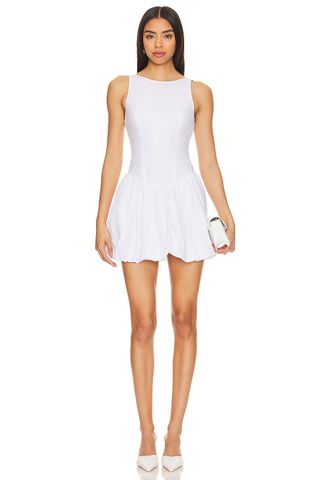 Model is wearing a white sleeveless bubble hem dress