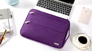Voova Protective Sleeve with Handle lying on a flat surface with an open Chromebook underneath it