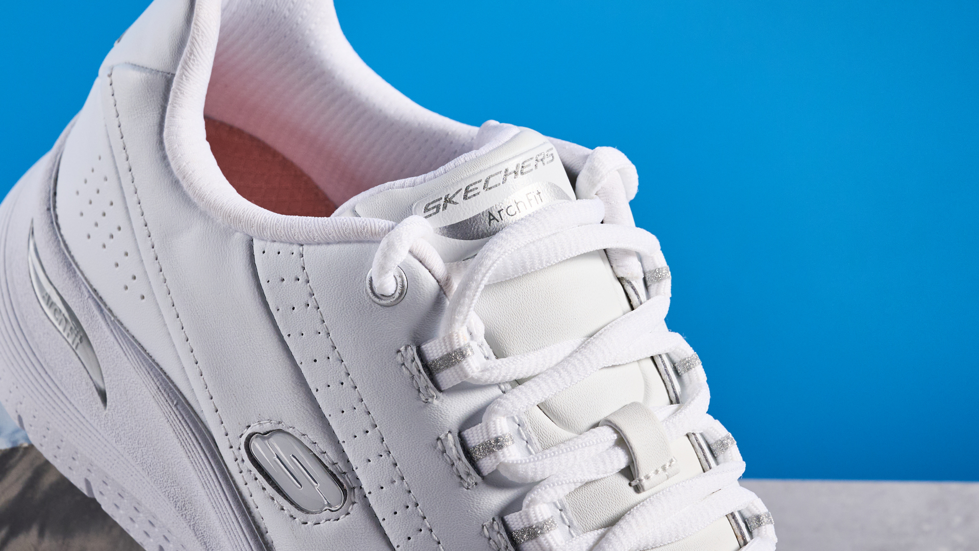 Skechers Arch Fit 2.0 Star Bound photographed in front of a blue background.