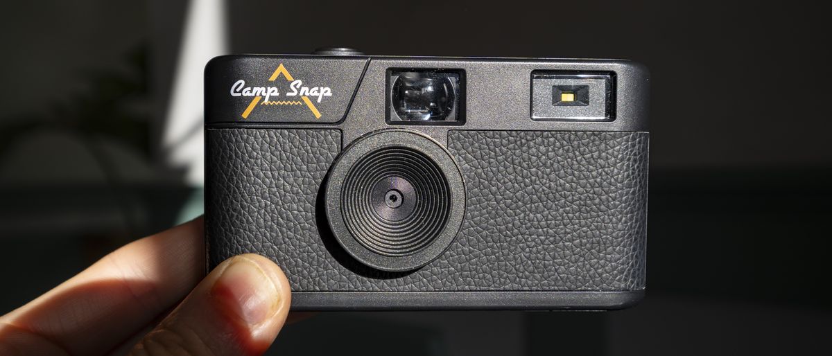 Camp Snap Camera in the hand illuminated by high contrast window light