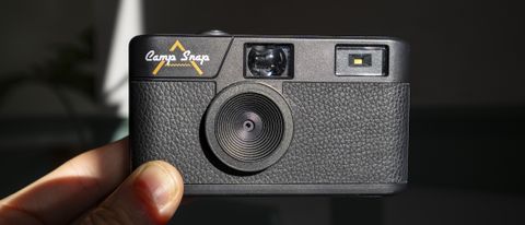 Camp Snap Camera in the hand illuminated by high contrast window light