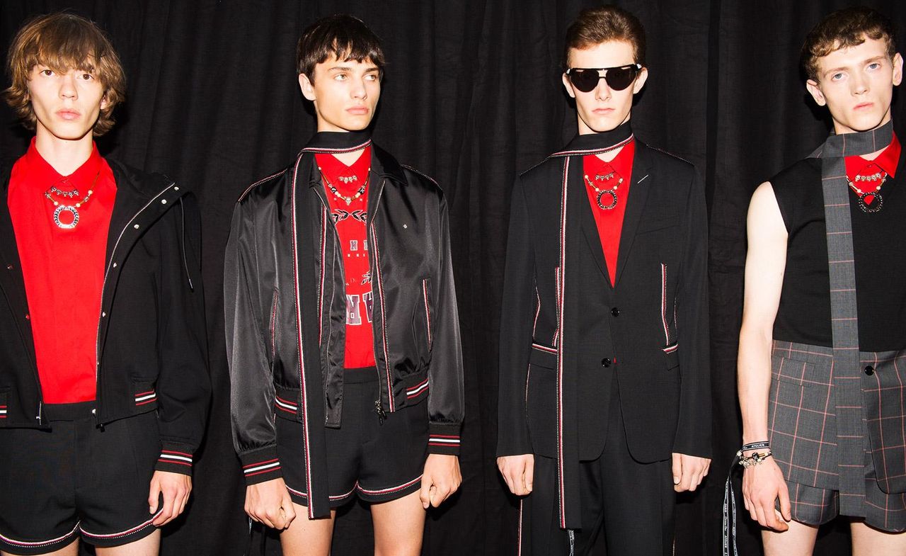 four male models wearing red tops with black blazers