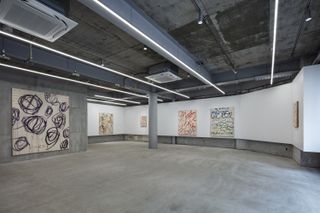 raw concrete gallery inside Nekoyacho Bldg by Suppose Design Office