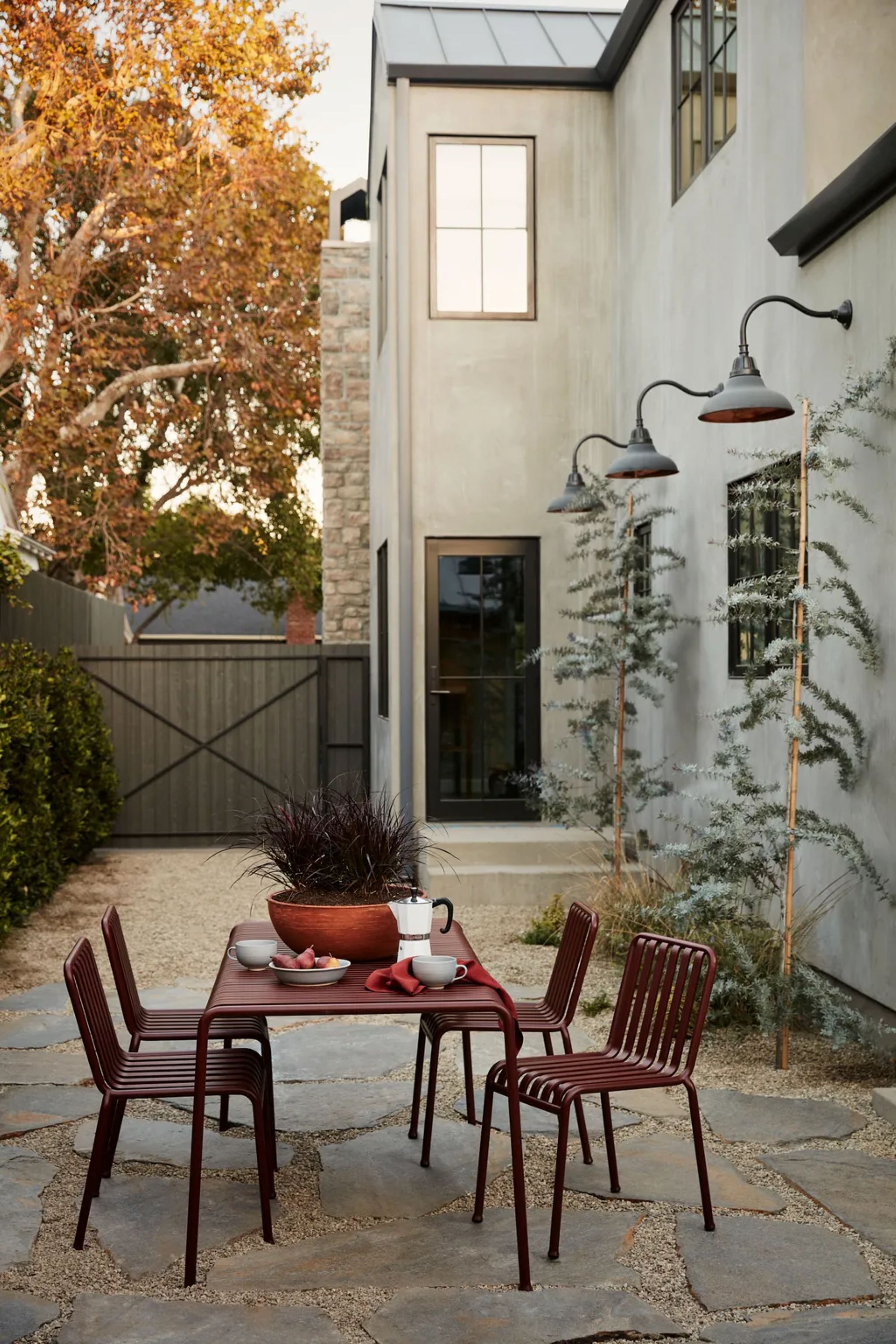 outdoor dining area with a red table and chairs