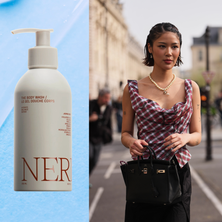 A woman with short hair styled to look wet holding a birkin, next to a bottle of body wash.