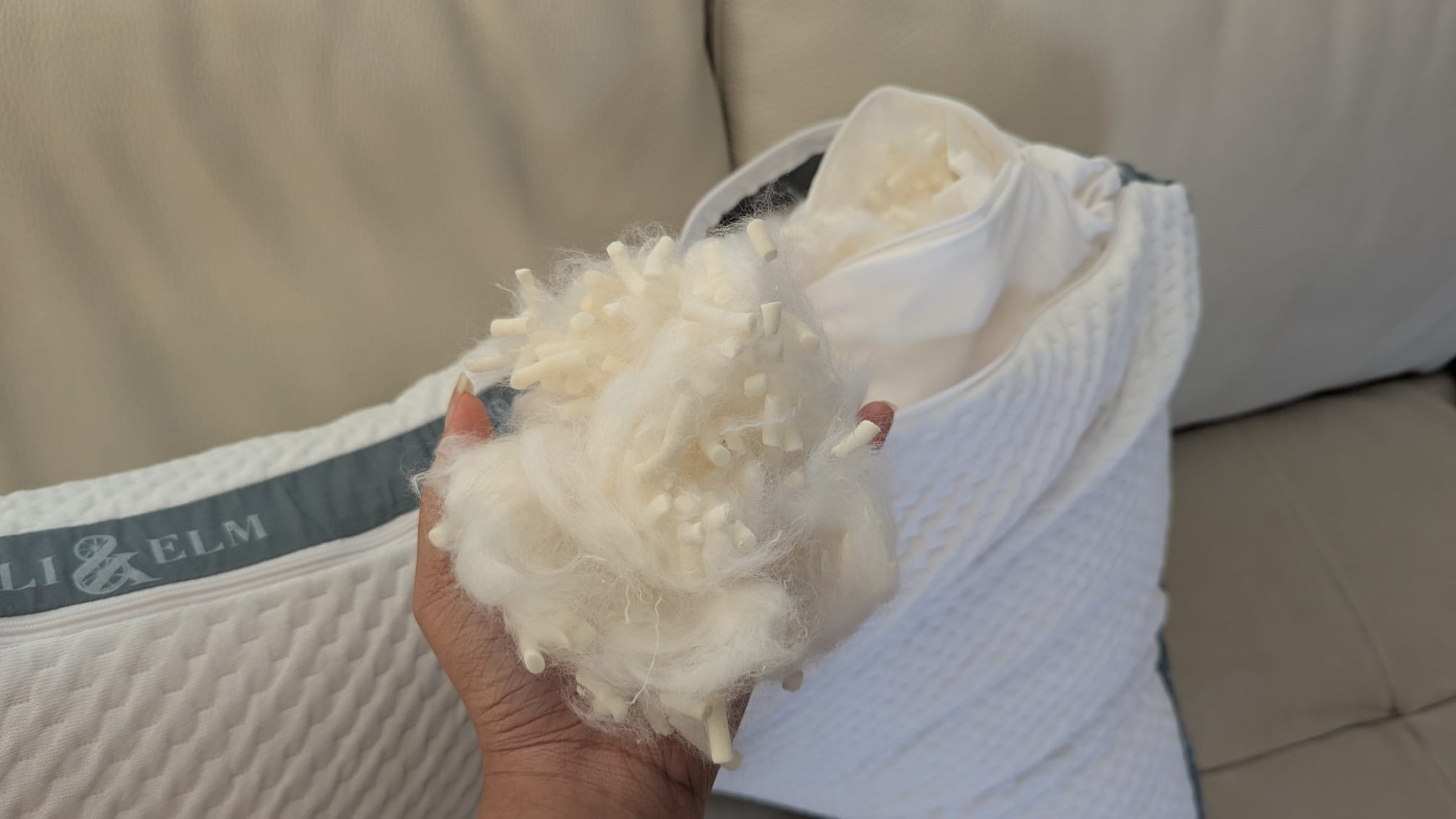 The memory foam and fiber fill held in hand 
