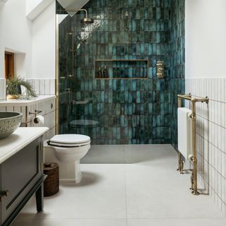 open plan shower with green wall of tiles