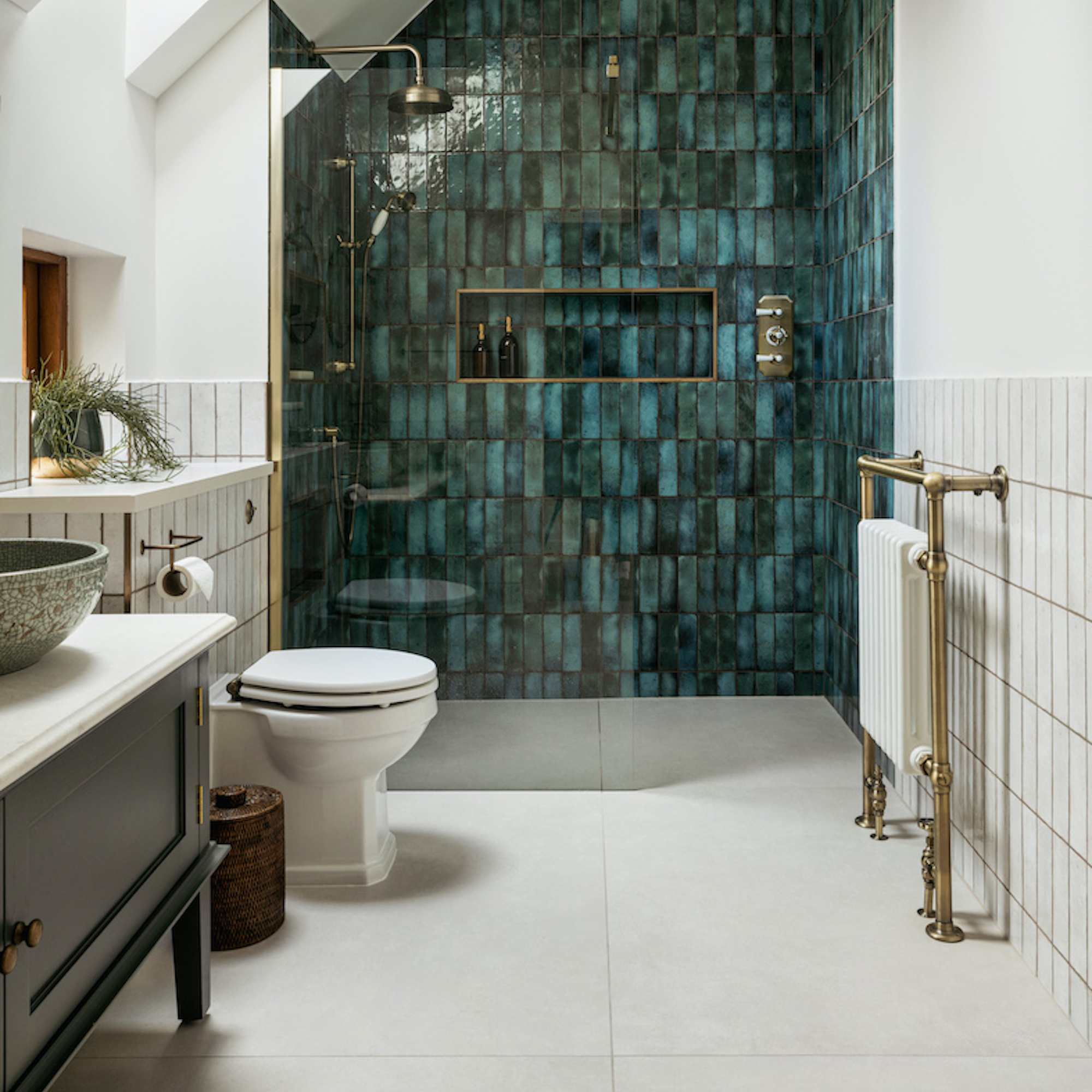 open plan shower with green wall of tiles
