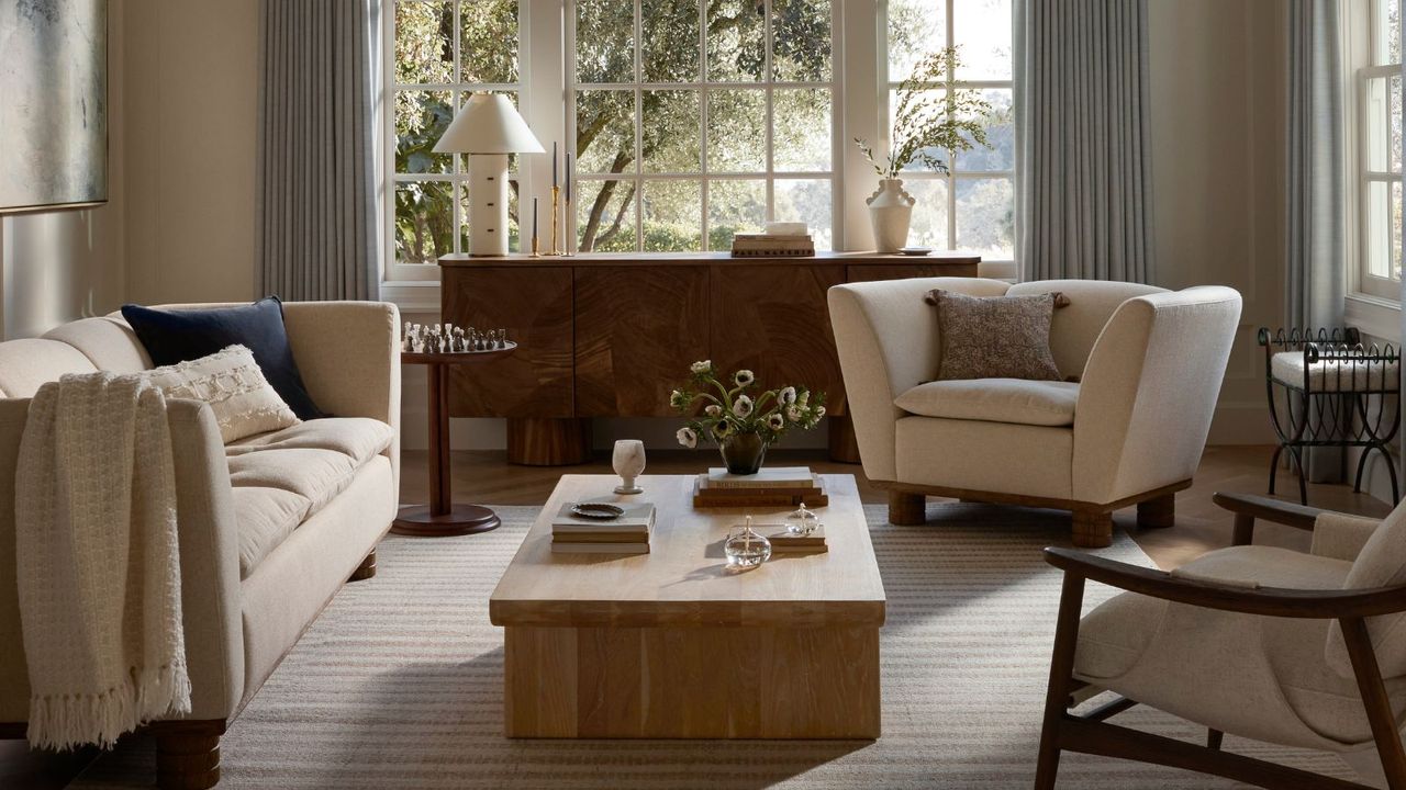 Living room with wood coffee table, cream armchair and sofa