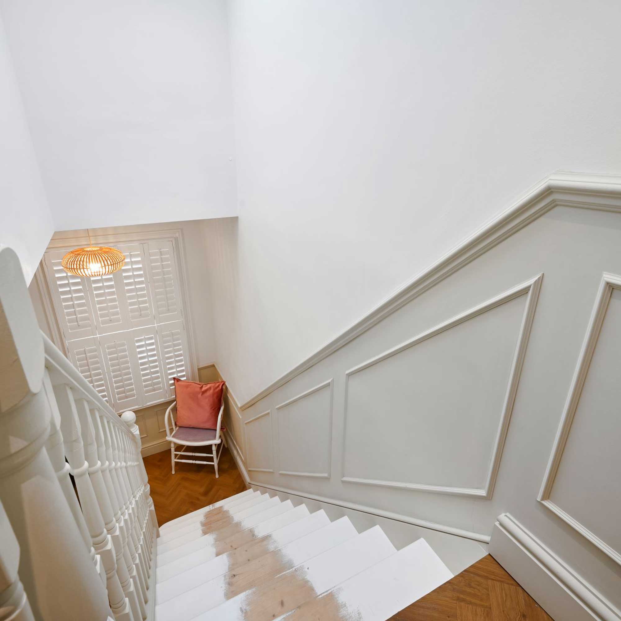 stairs leading from loft conversion with half wall panelling