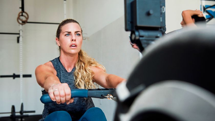 Woman using rowing machine in gym