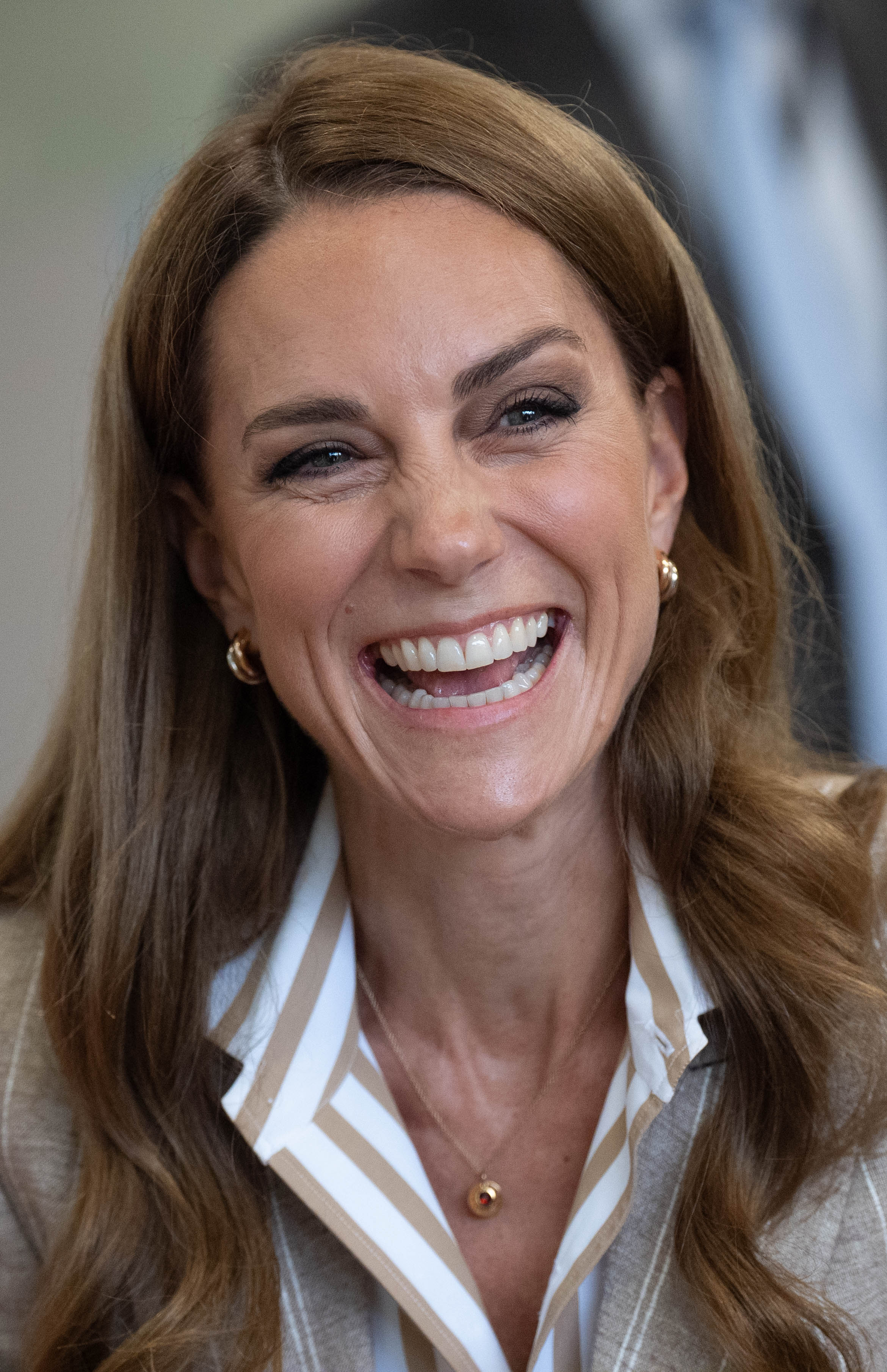 Princess Kate wearing a striped shirt and laughing