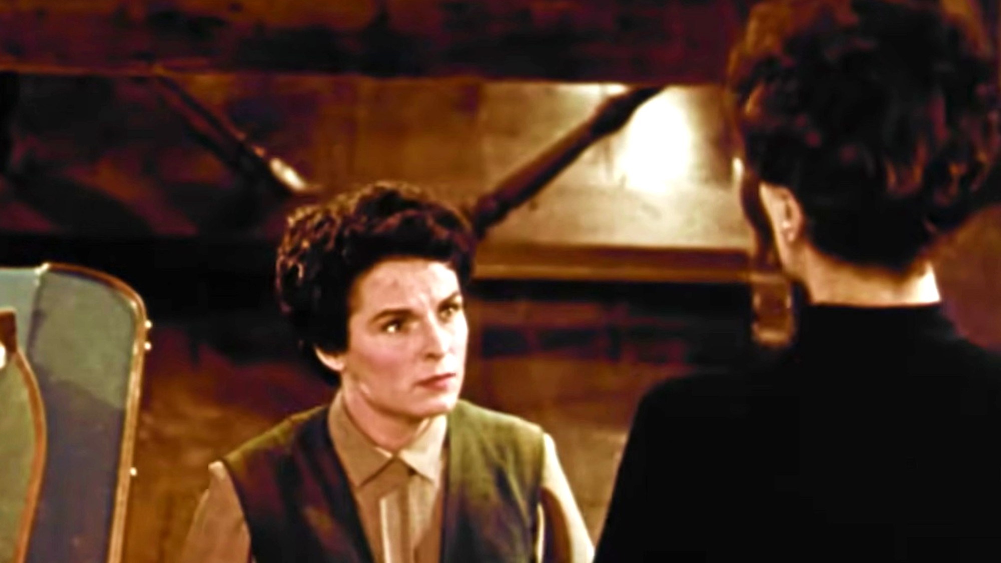 Mercedes McCambridge staring up at Joan Crawford on a staircase in Johnny Guitar