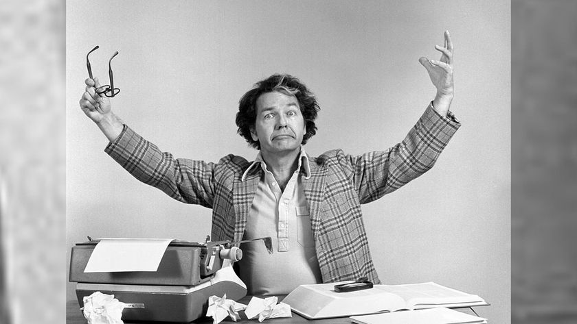 man at desk with typewriter