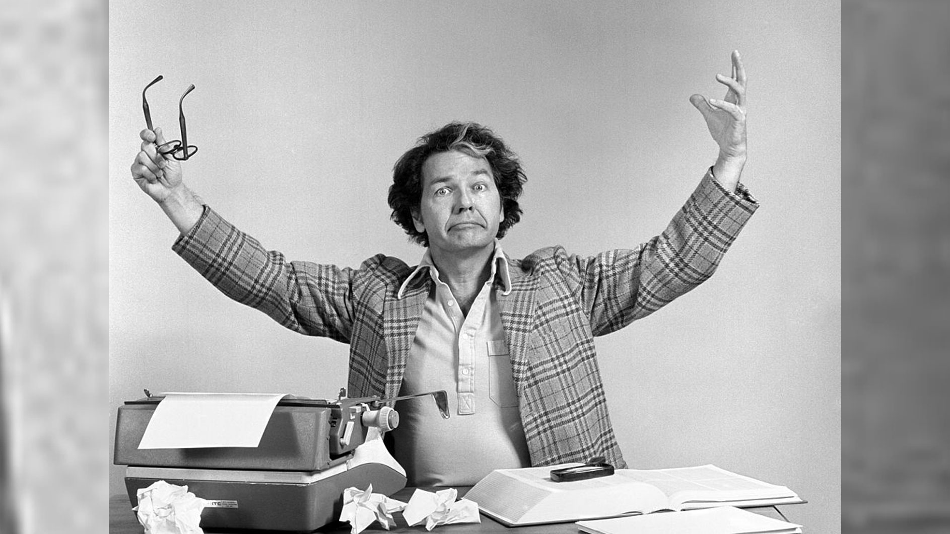 man at desk with typewriter