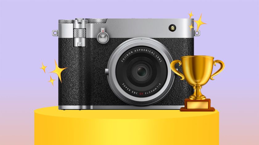 Fujifilm GFX100RF on a golden pedestal, next to a trophy on a purple beige background 