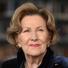 A headshot of Queen Sonja in a navy jacket