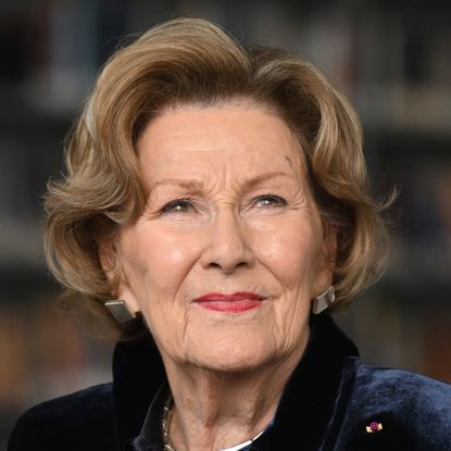 A headshot of Queen Sonja in a navy jacket